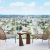 a table and chairs on a balcony overlooking a city