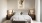 a bed with a poster on the wall