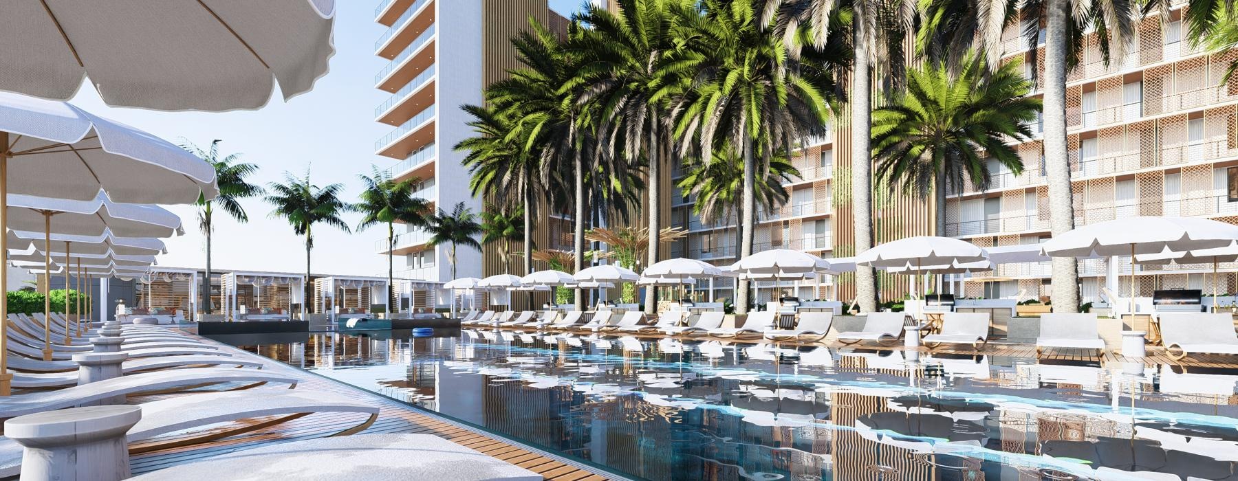 a pool with lounge chairs and umbrellas by a building